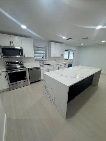 a bathroom with a toilet a sink and shower