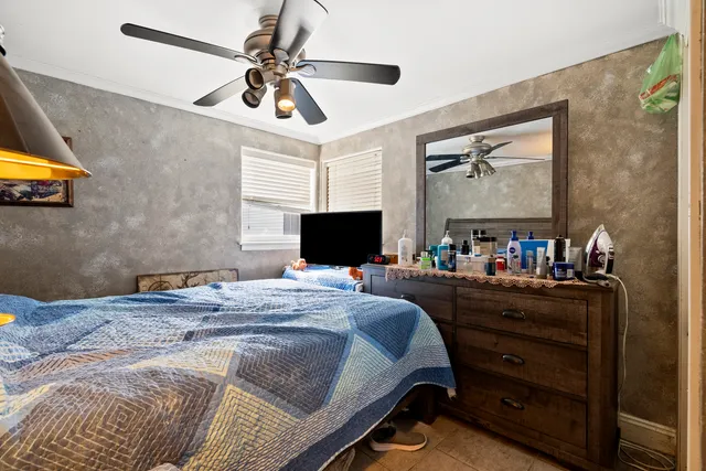 a bedroom with a bed and a television