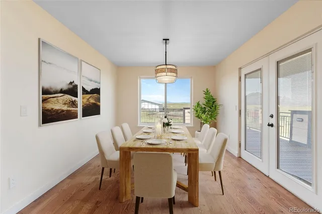 a dining room with furniture window and wooden floor