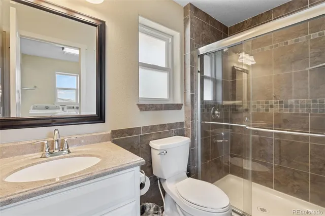 an empty room with wooden floor chandelier fan and closet area