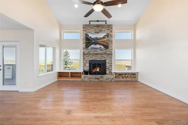 a view of an empty room with window and fire place