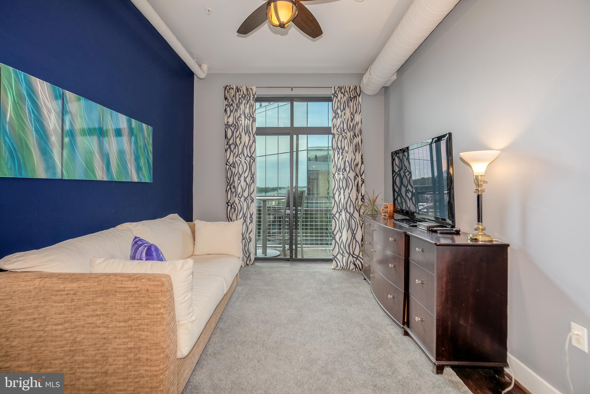 525 Water Street Southwest, Unit 403 Washington, DC 20024 - Photo 15 of 35 a bed room with a bed and a television