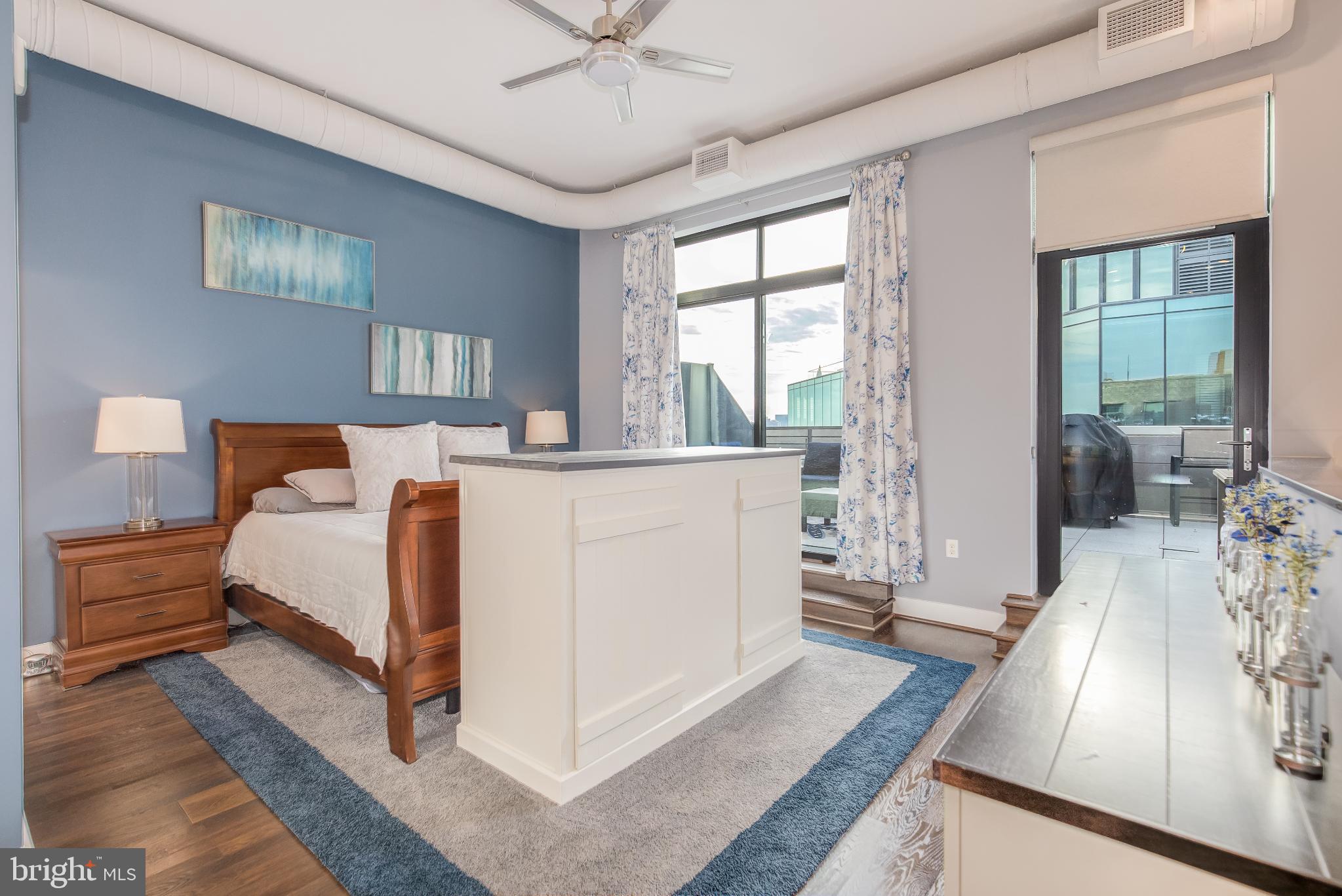 525 Water Street Southwest, Unit 403 Washington, DC 20024 - Photo 23 of 35 a bed room with a bed and a large window