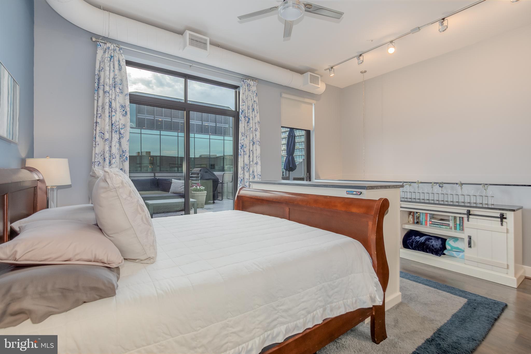 525 Water Street Southwest, Unit 403 Washington, DC 20024 - Photo 25 of 35 a bedroom with a large bed and a large window