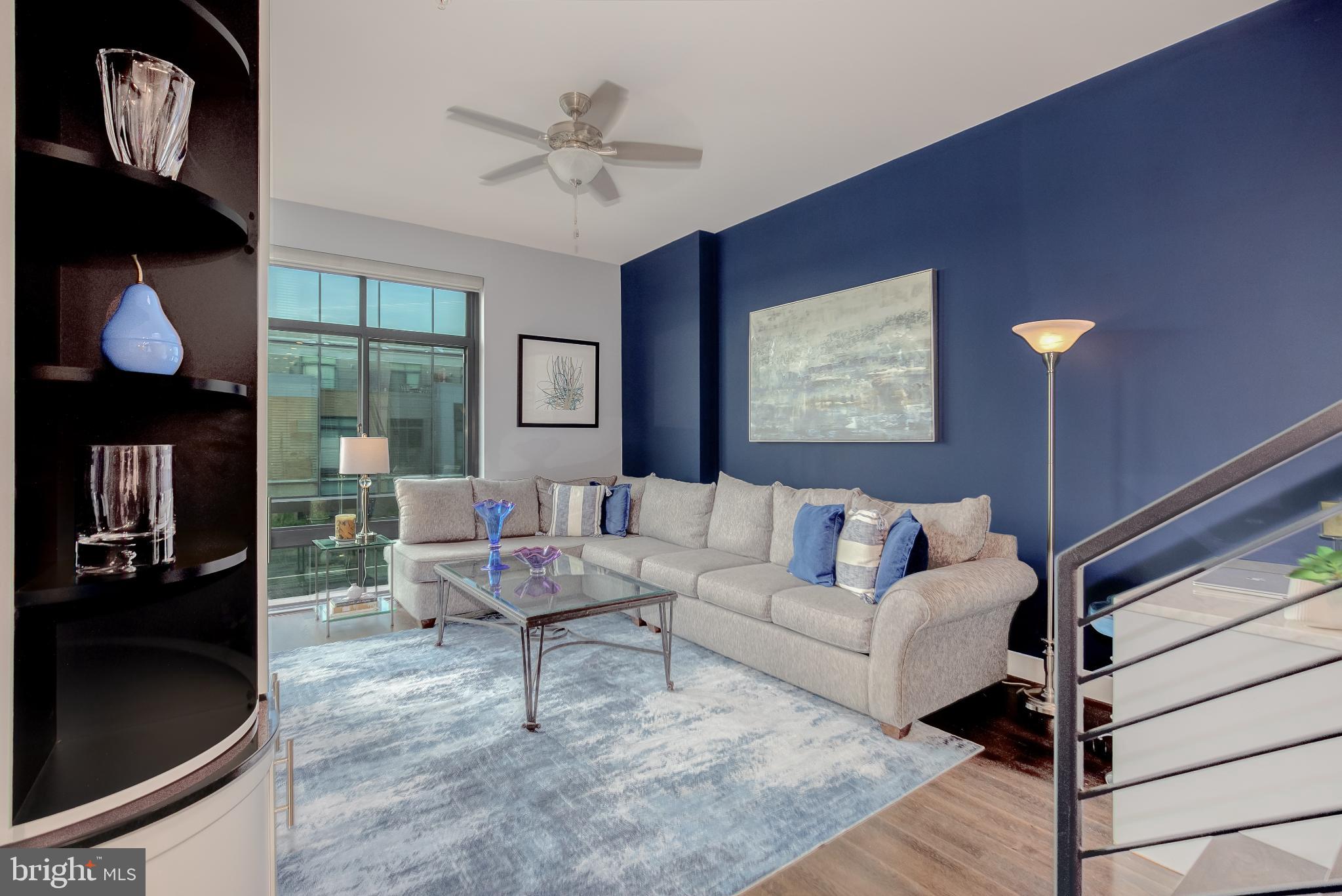 525 Water Street Southwest, Unit 403 Washington, DC 20024 - Photo 3 of 35 a living room with furniture and a flat screen tv