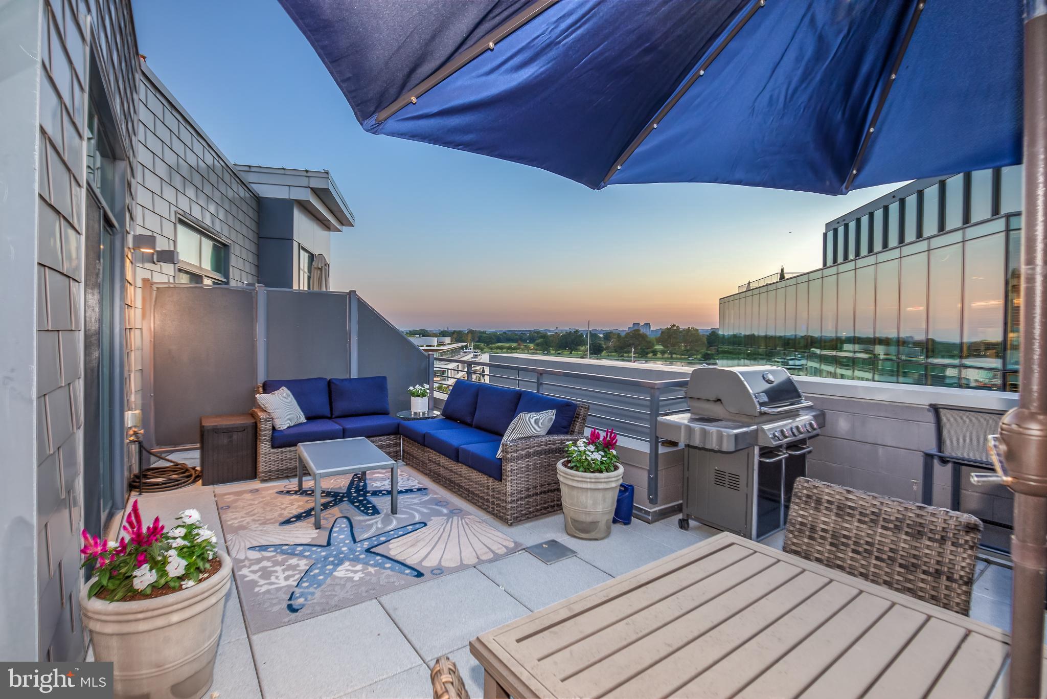 525 Water Street Southwest, Unit 403 Washington, DC 20024 - Photo 31 of 35 a view of a chairs and table on the roof deck