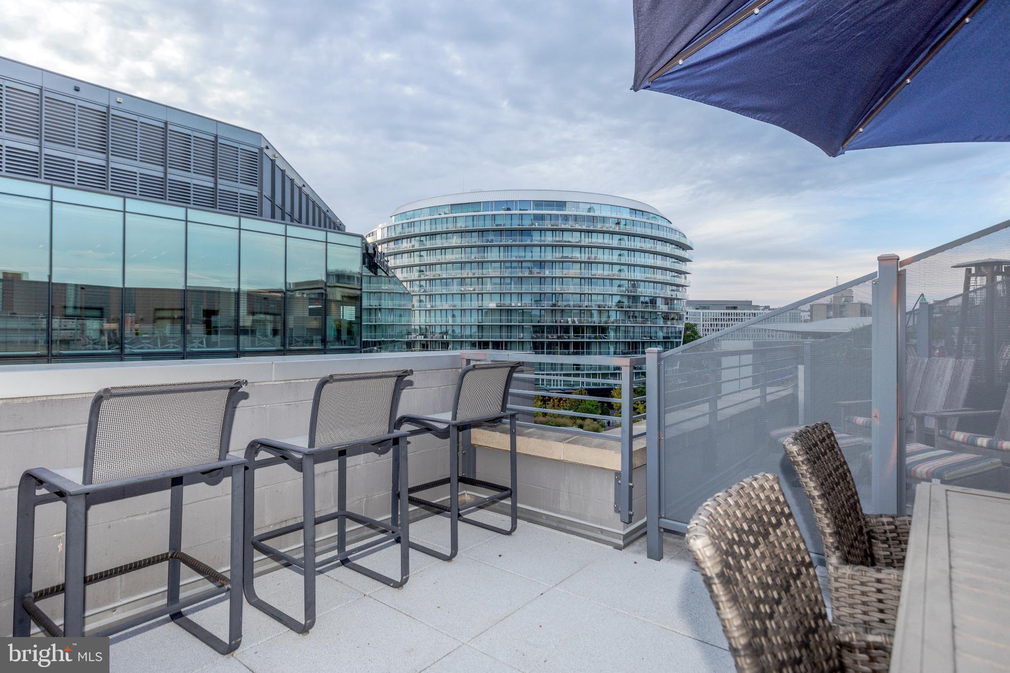 525 Water Street Southwest, Unit 403 Washington, DC 20024 - Photo 34 of 35 a patio with a table and chairs