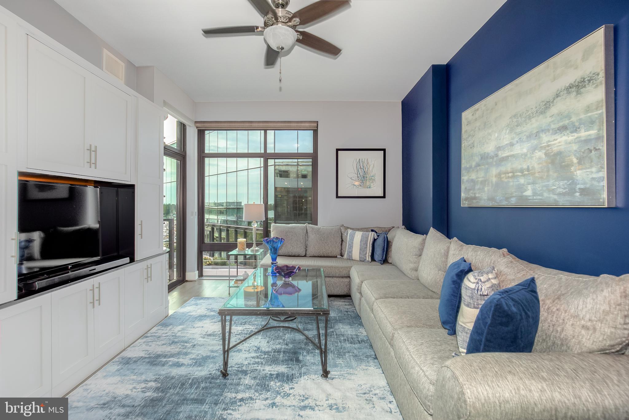 525 Water Street Southwest, Unit 403 Washington, DC 20024 - Photo 5 of 35 a living room with furniture and a flat screen tv