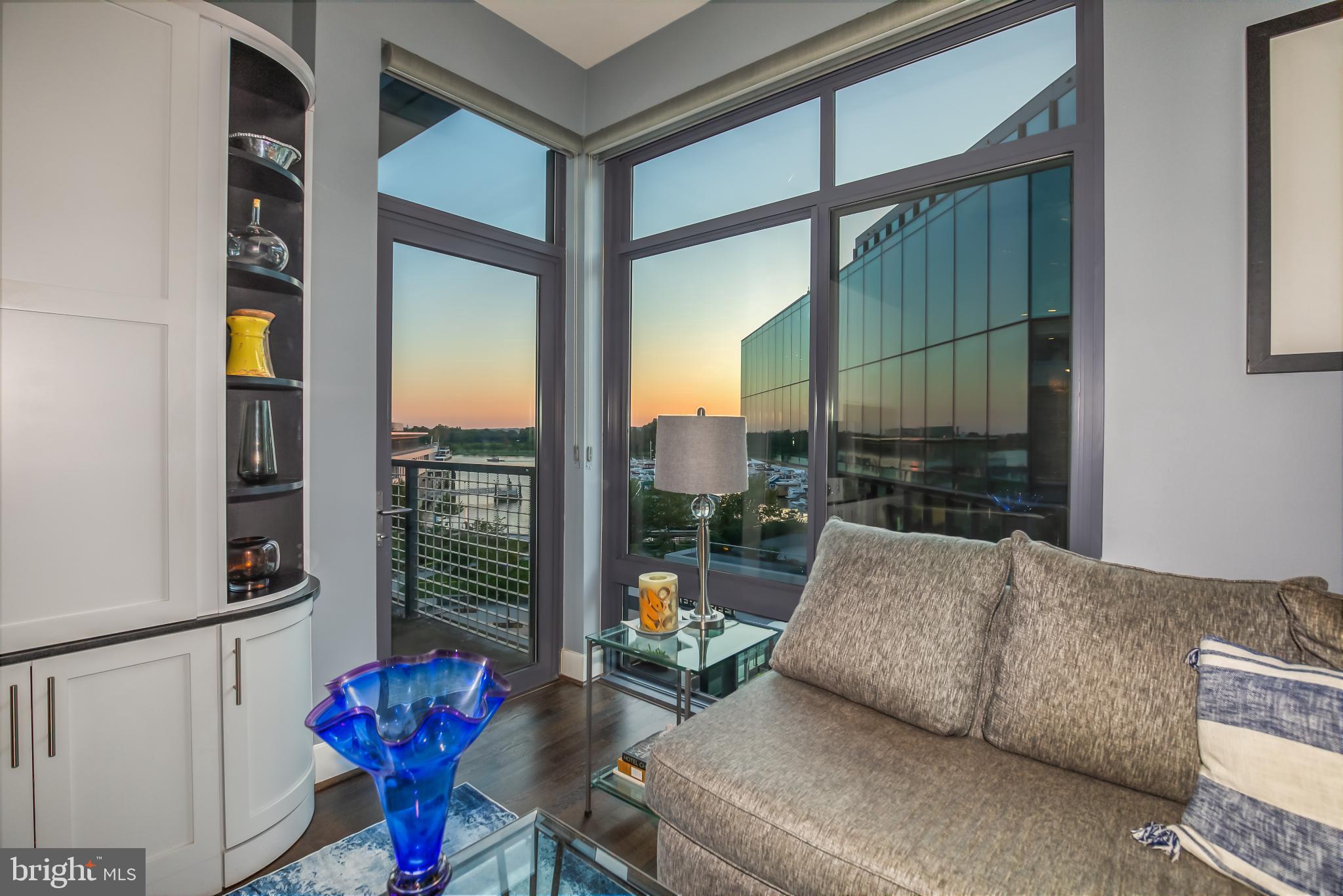 525 Water Street Southwest, Unit 403 Washington, DC 20024 - Photo 7 of 35 a living room with furniture and a floor to ceiling window
