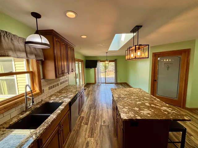 a kitchen with sink and refrigerator
