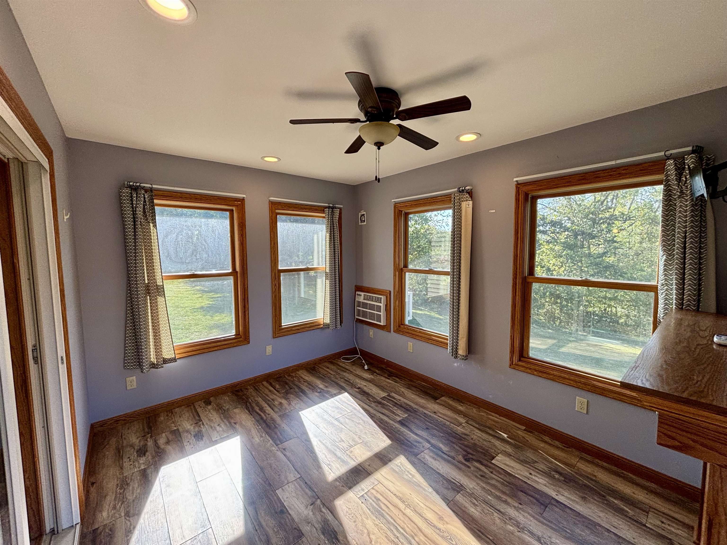 3310 South Apple River Road Elizabeth, IL 61028 - Photo 17 of 39 a view of an empty room with wooden floor and a window
