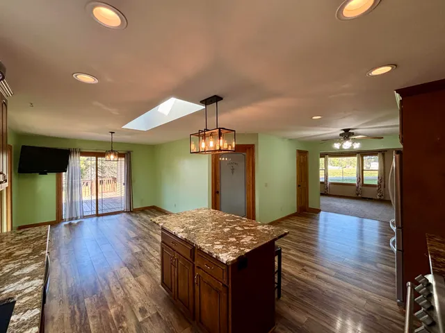 wooden floor with kitchen view