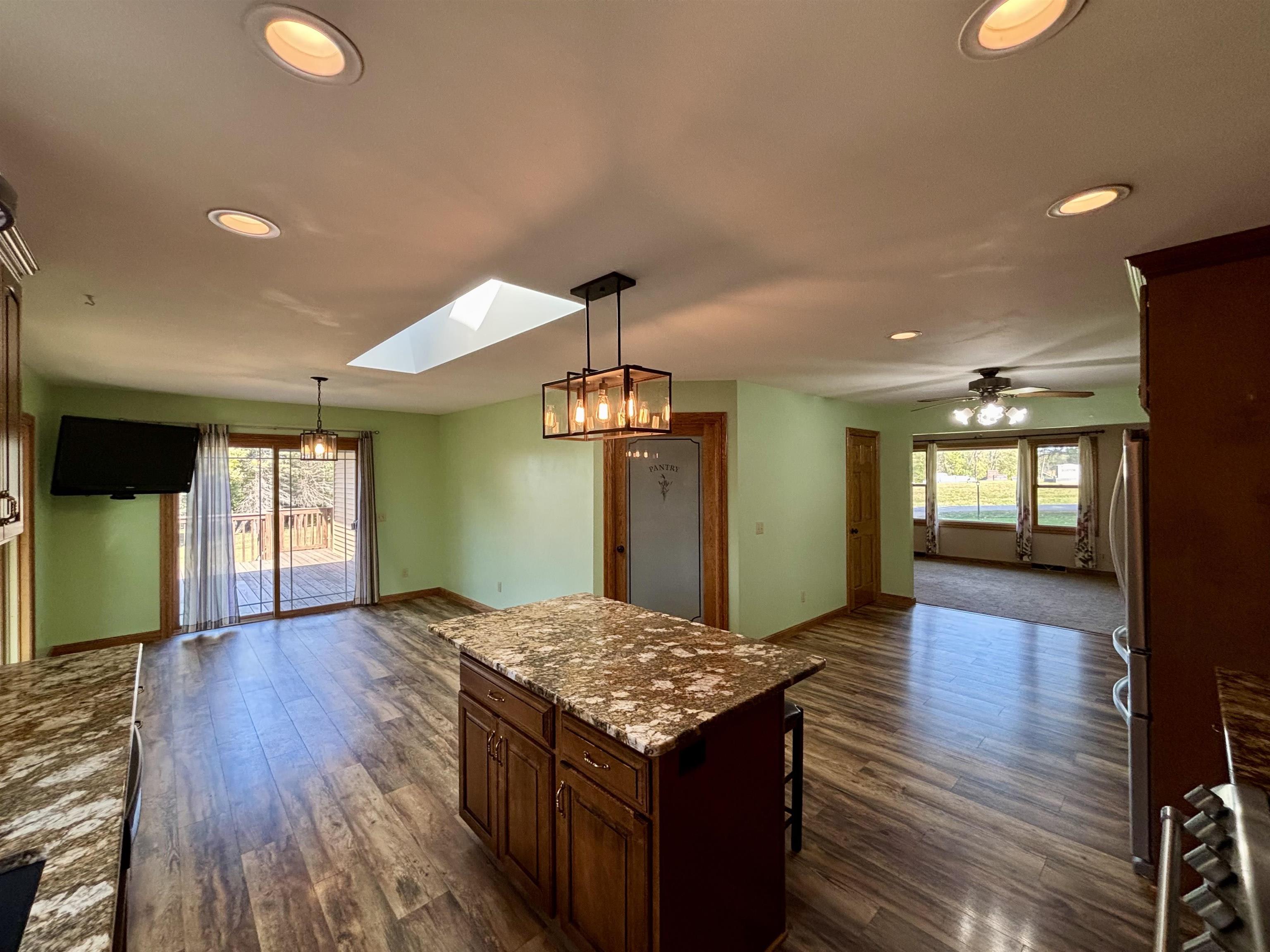 3310 South Apple River Road Elizabeth, IL 61028 - Photo 19 of 39 wooden floor with kitchen view