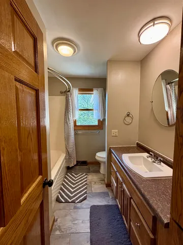 a spacious bathroom with a double vanity sink and a mirror