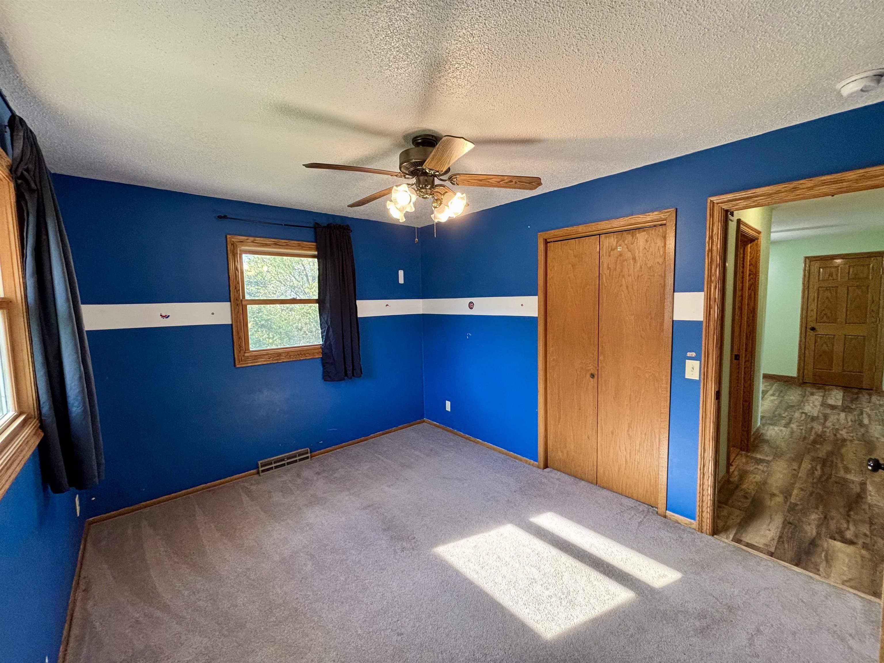 3310 South Apple River Road Elizabeth, IL 61028 - Photo 24 of 39 a view of a livingroom with a chandelier fan and a window