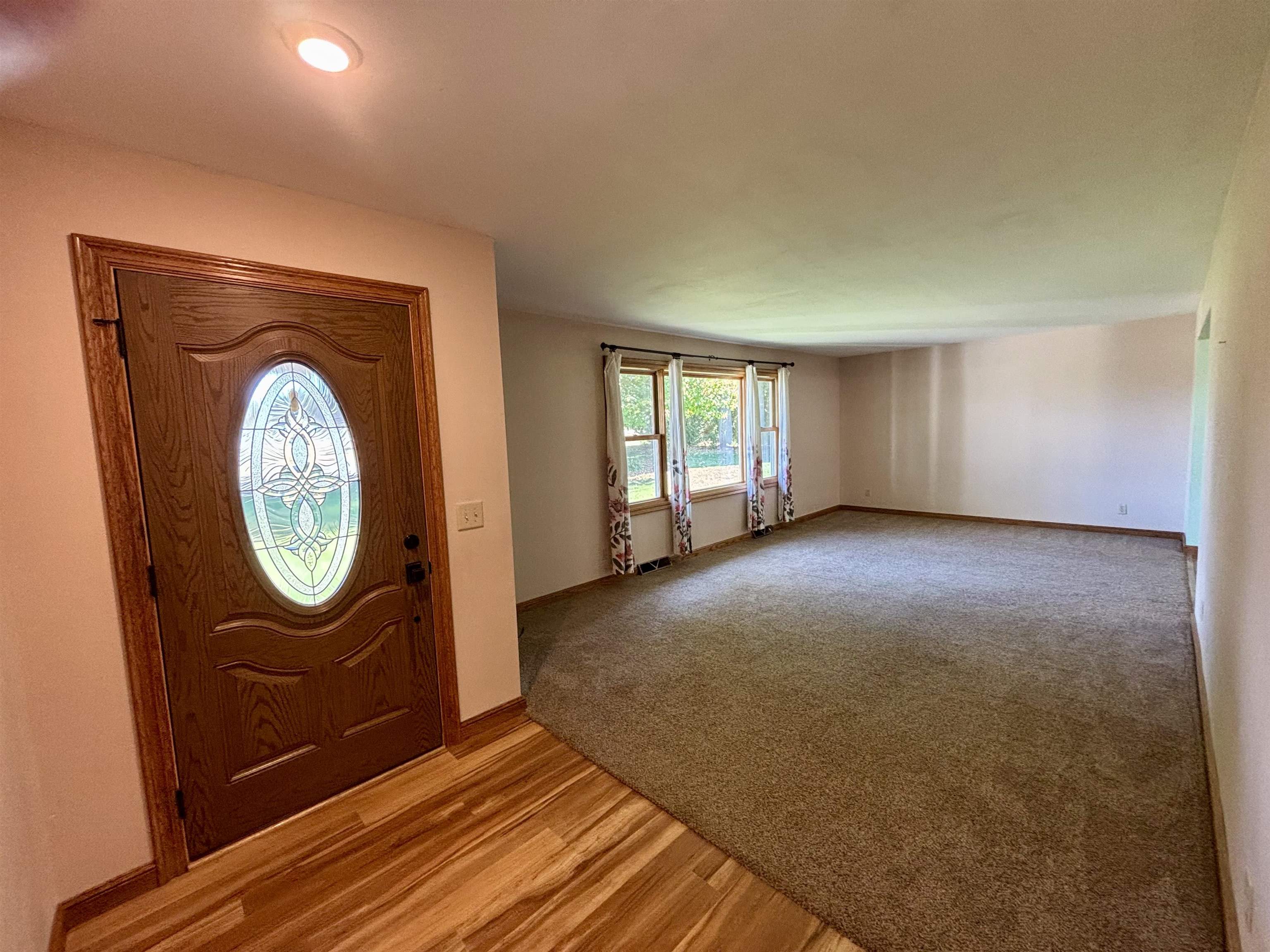 3310 South Apple River Road Elizabeth, IL 61028 - Photo 7 of 39 a view of a livingroom with furniture wooden floor and a window