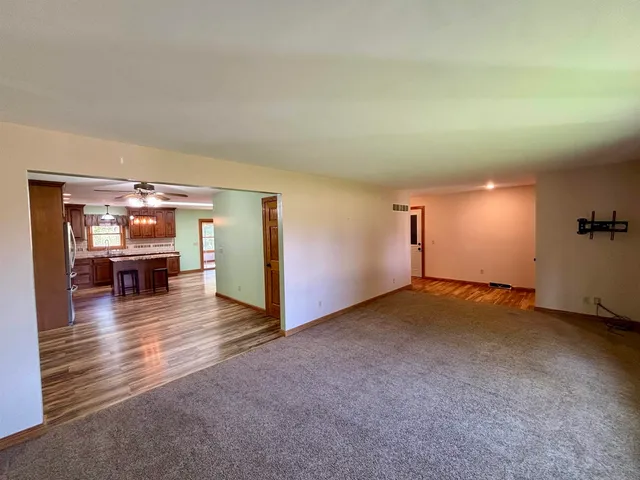 a view of a livingroom with furniture and an umbrella