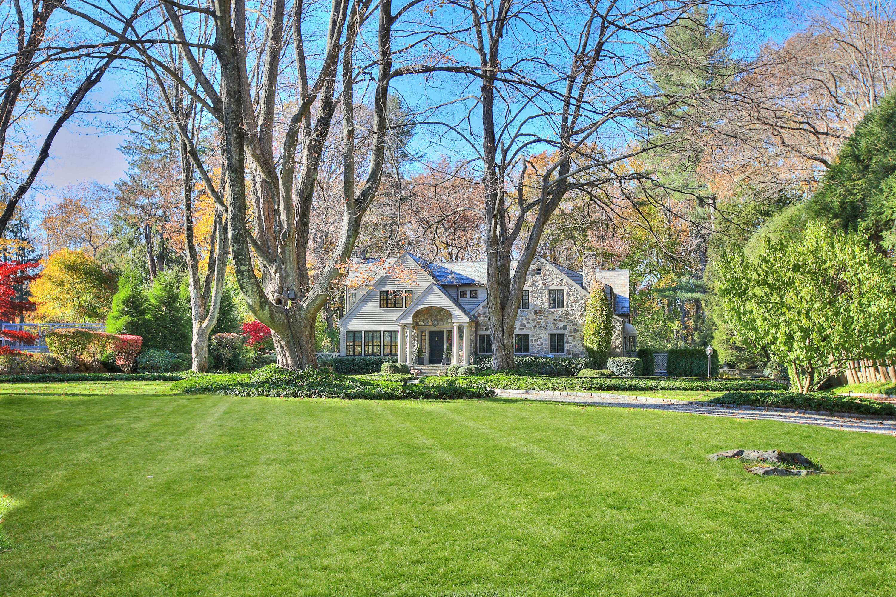 22 Mill Road New Canaan, CT 06840 - Photo 2 of 42 a front view of a building with trees