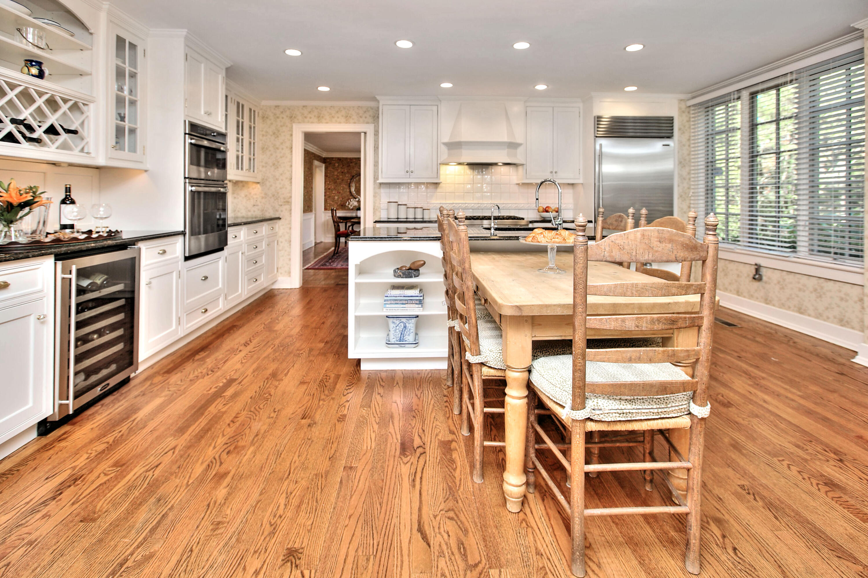 22 Mill Road New Canaan, CT 06840 - Photo 21 of 42 a kitchen with stainless steel appliances kitchen island granite countertop a stove a sink and a refrigerator with wooden floor