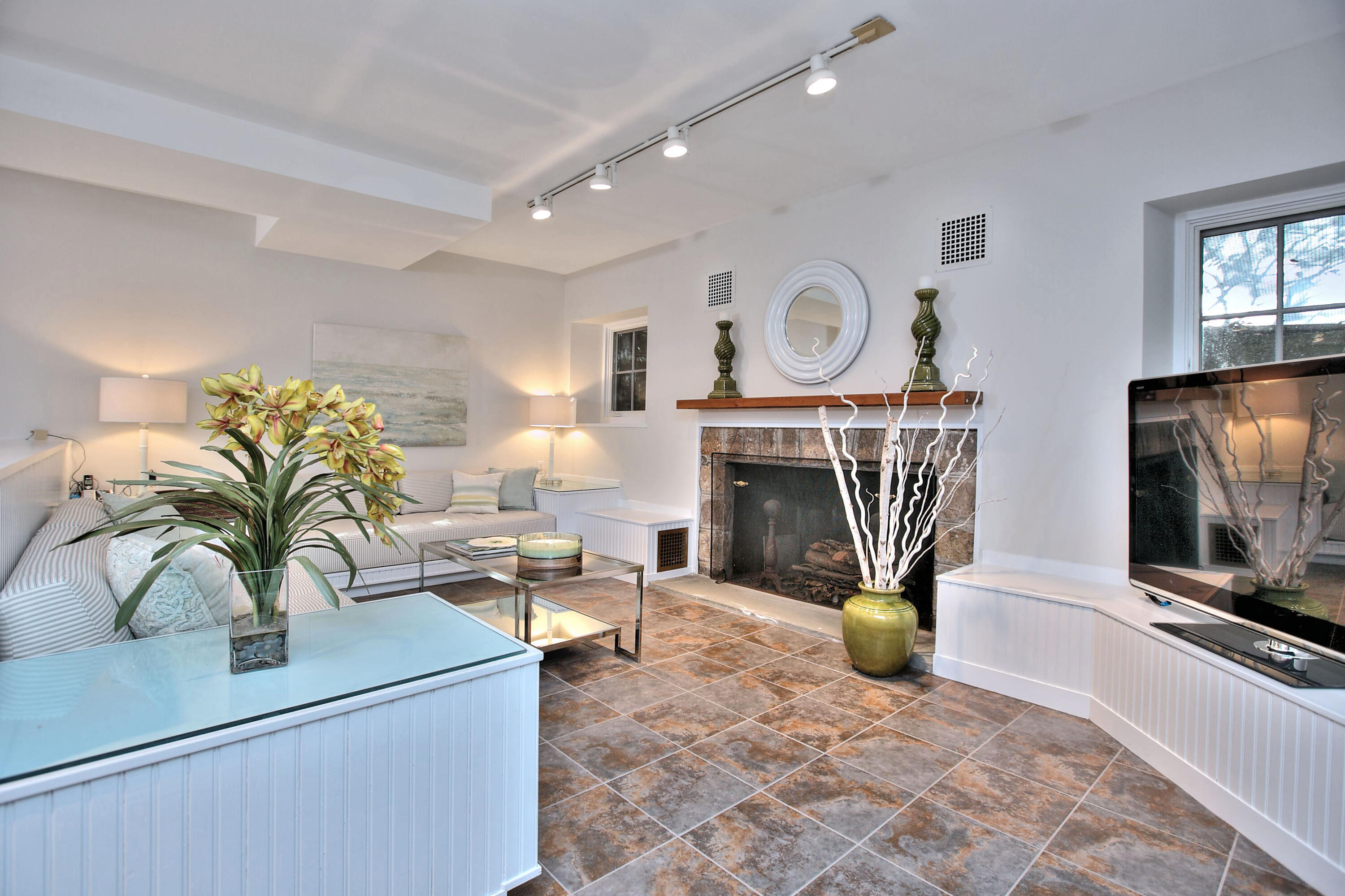 22 Mill Road New Canaan, CT 06840 - Photo 33 of 42 a living room with furniture a flat screen tv and a fireplace