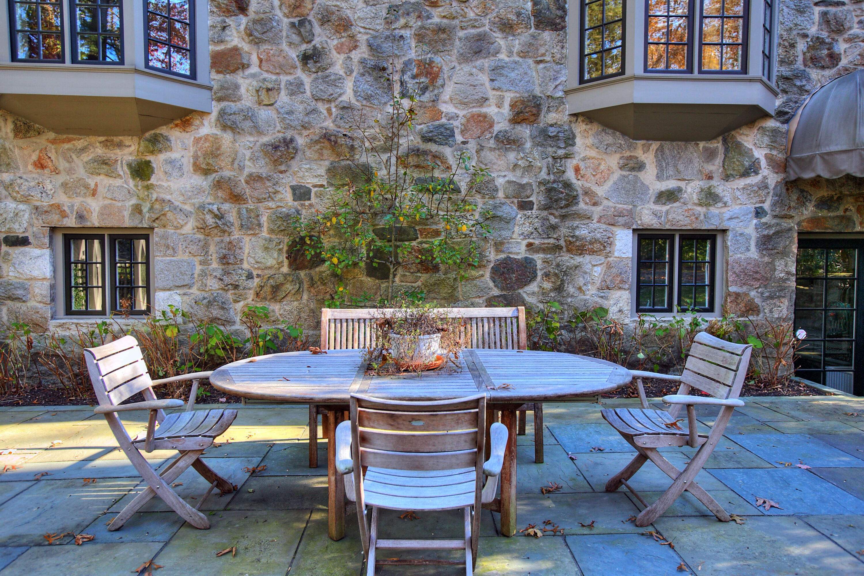 22 Mill Road New Canaan, CT 06840 - Photo 38 of 42 a view of a patio with table and chairs under an umbrella
