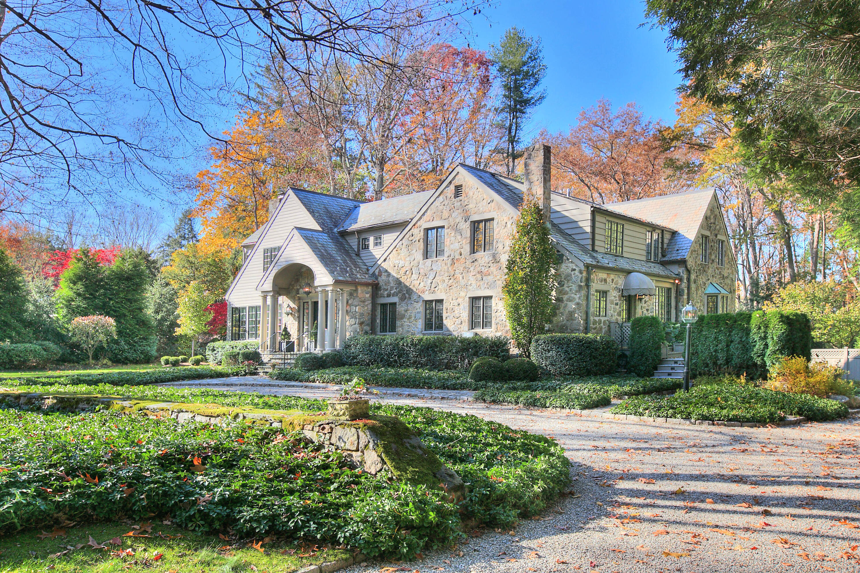 22 Mill Road New Canaan, CT 06840 - Photo 41 of 42 a front view of a house with a yard