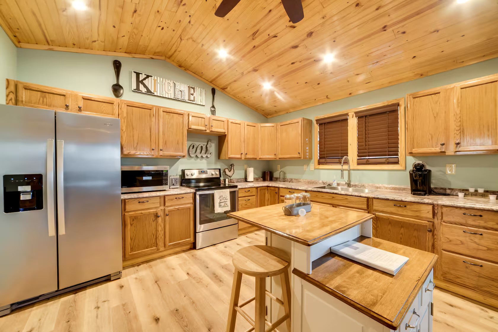 3000 Highwater Road Waverly, TN 37185 - Photo 7 of 26 a kitchen with stainless steel appliances granite countertop a sink refrigerator and cabinets