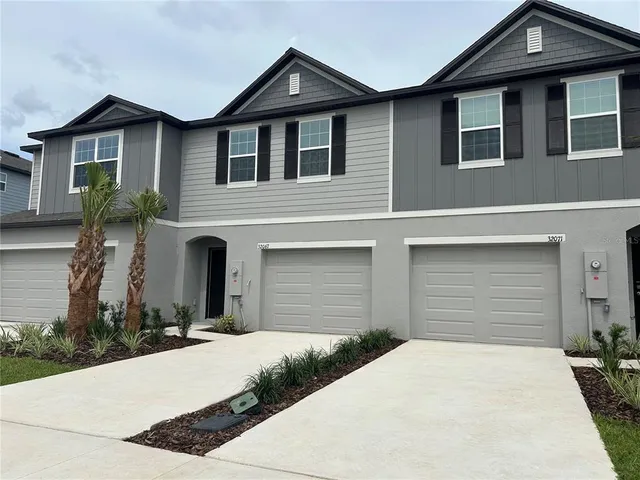 a front view of a house with a yard and garage