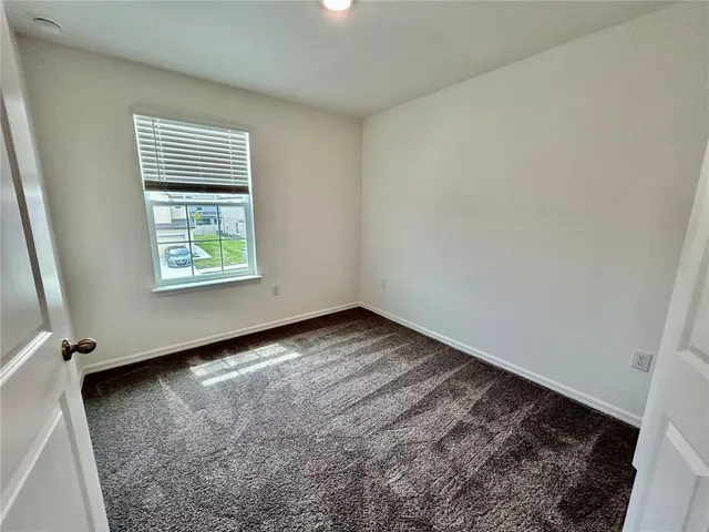 an entryway door with wooden floor