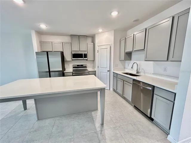 a large kitchen with a table and chairs