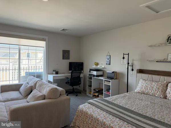 a bedroom with bed and window