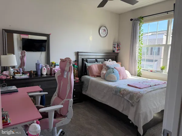 a bathroom with a toilet and a shower curtain
