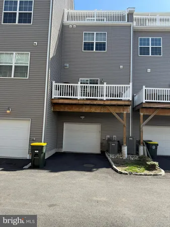 a view of balcony with wooden floor chairs and wooden fence