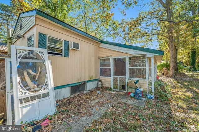 a view of a house with a tree in the yard