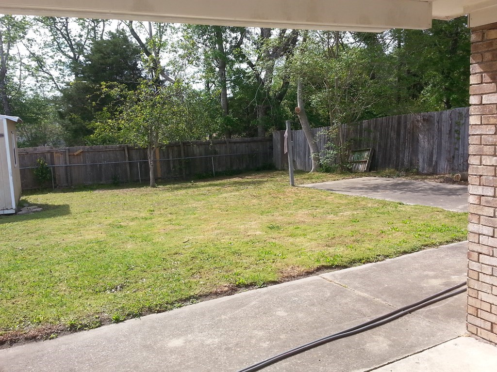 9 Crown Court Columbus, GA 31909 - Photo 2 of 3 a swimming pool with wooden fence