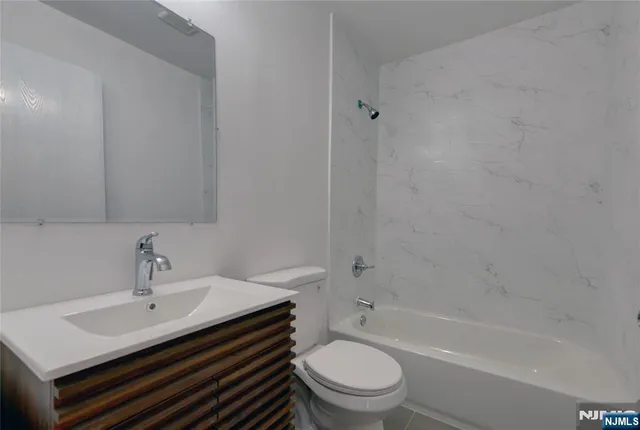 a bathroom with a sink toilet a bathtub and vanity