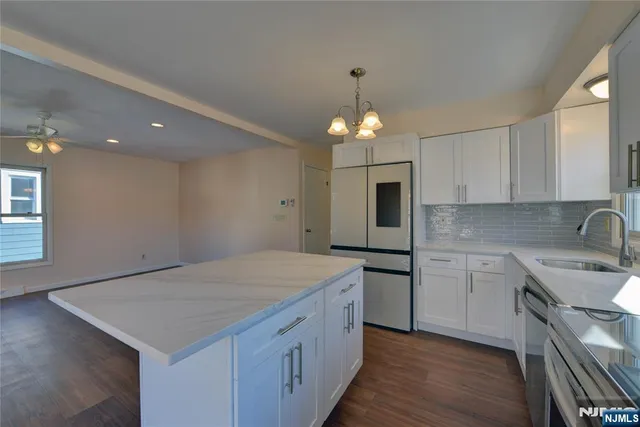 a kitchen with a stove a sink and a refrigerator