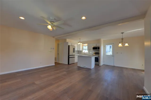 a view of a kitchen with wooden floor and a kitchen