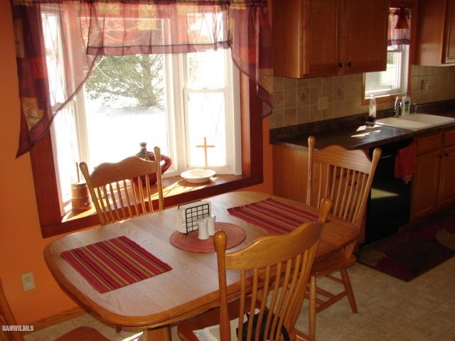 3287 East Lamm Road Freeport, IL 61032 - Photo 7 of 25 a view of a dining room with furniture a chandelier and wooden floor