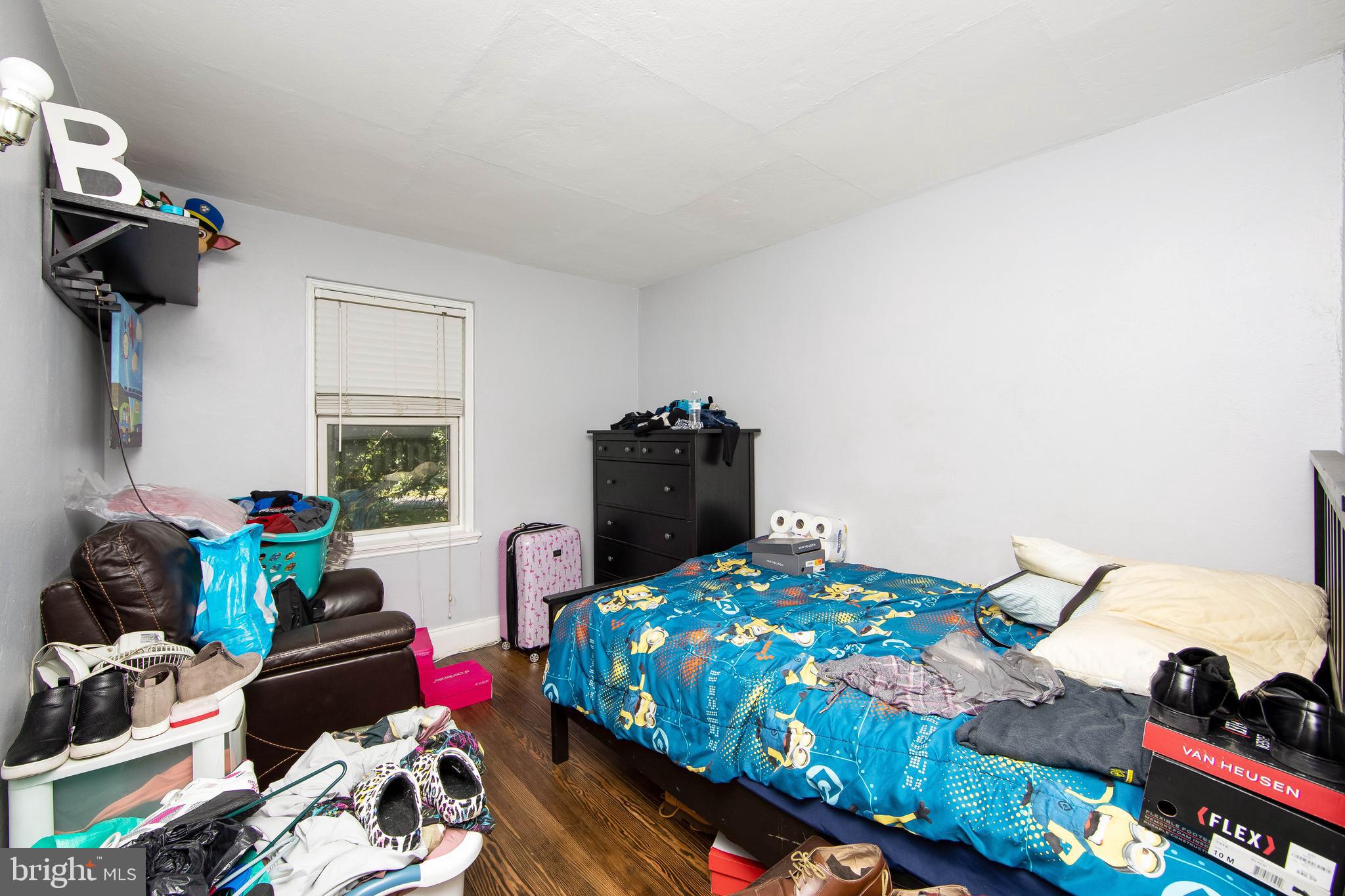 2832 Kansas Road Camden, NJ 08104 - Photo 11 of 32 a bedroom with a bed and wooden floor