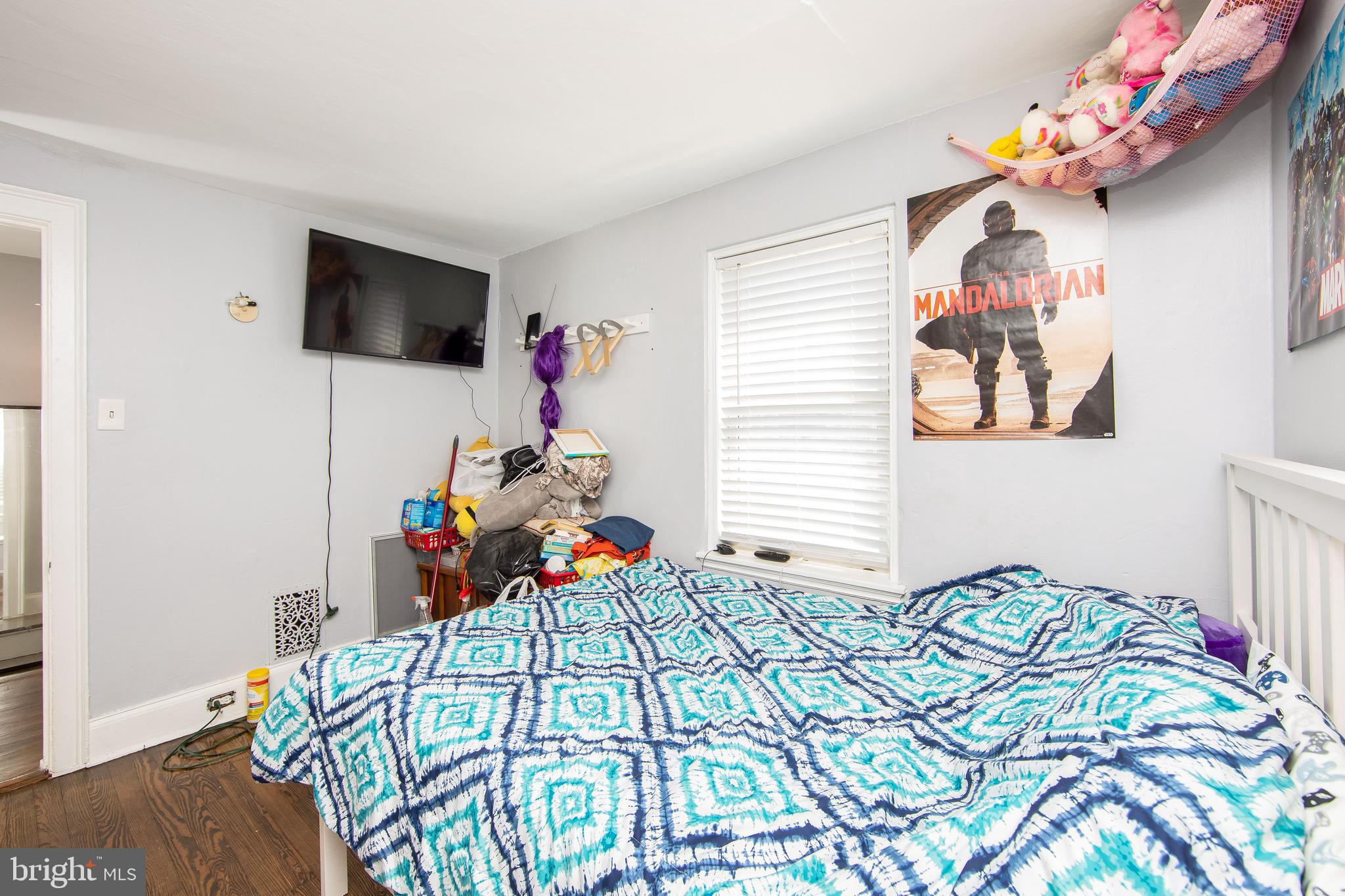 2832 Kansas Road Camden, NJ 08104 - Photo 19 of 32 a bedroom with a bed and a flat screen tv