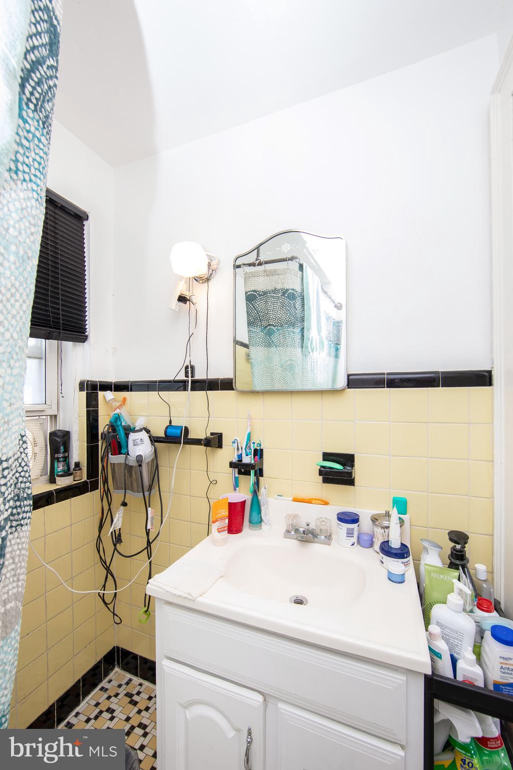 2832 Kansas Road Camden, NJ 08104 - Photo 22 of 32 a bathroom with a sink and a mirror