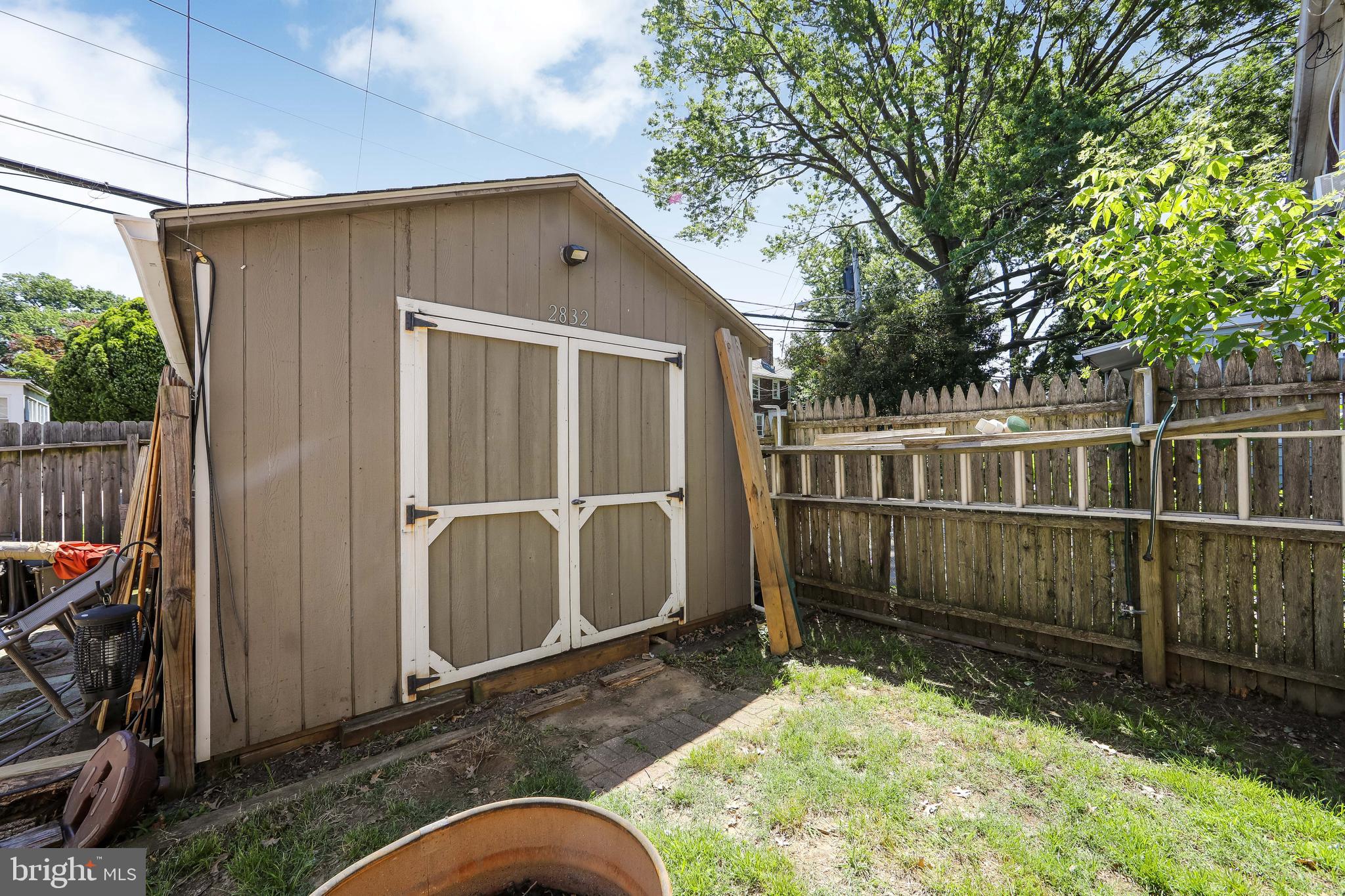 2832 Kansas Road Camden, NJ 08104 - Photo 29 of 32 a backyard of a house with a large tree and wooden fence