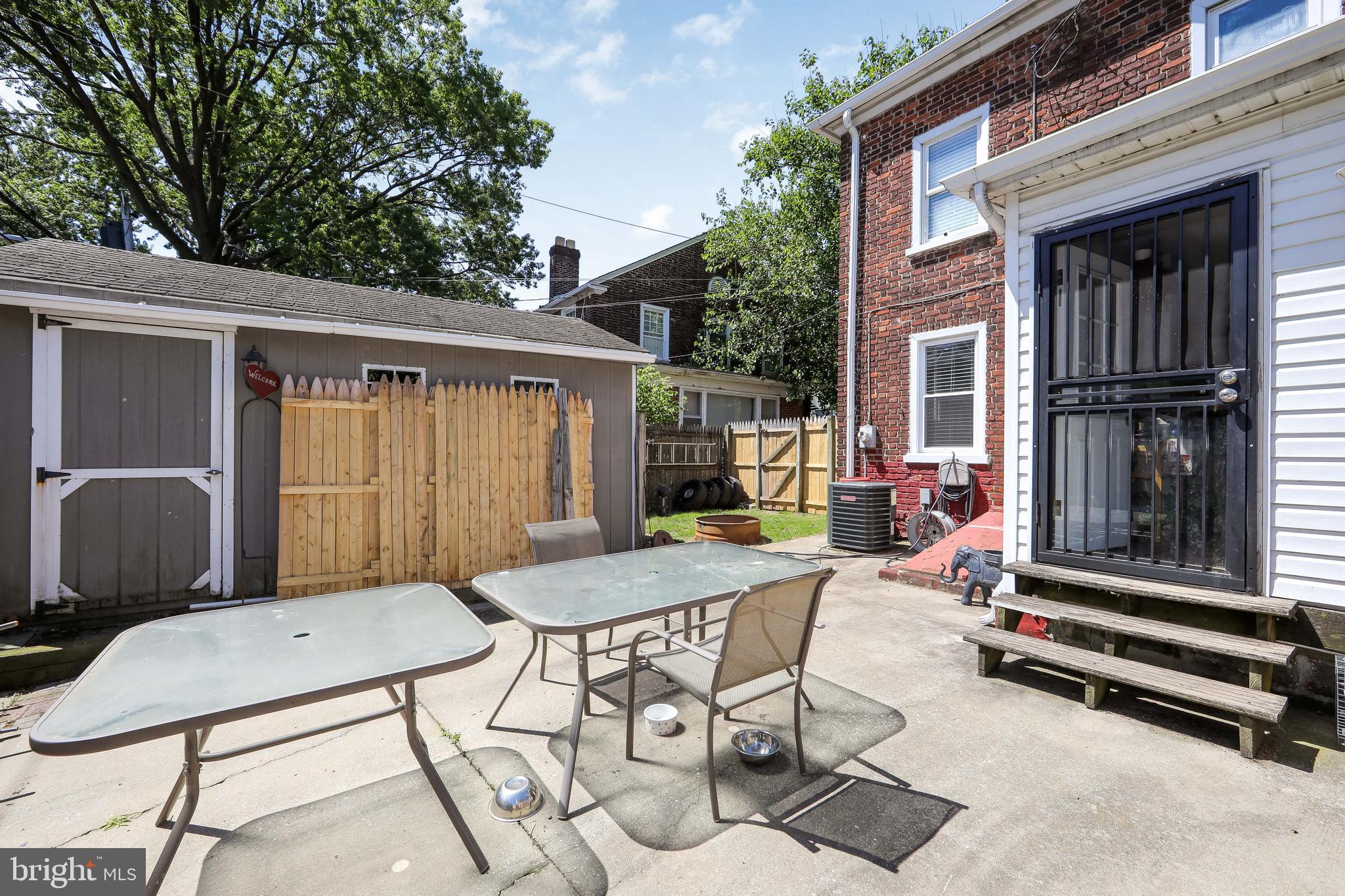 2832 Kansas Road Camden, NJ 08104 - Photo 32 of 32 a backyard of a house with barbeque oven table and chairs