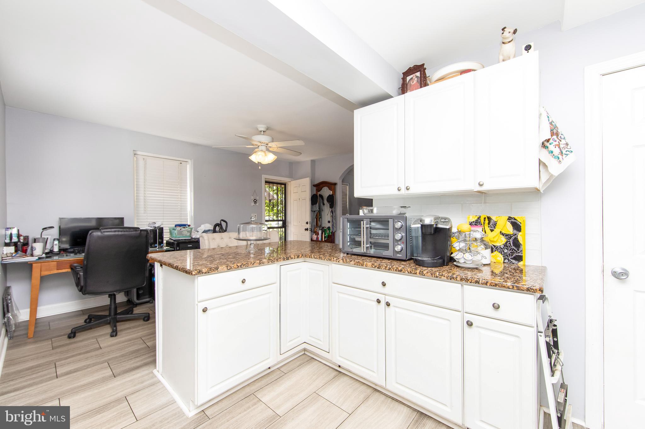 2832 Kansas Road Camden, NJ 08104 - Photo 8 of 32 a kitchen with sink cabinets and outdoor view