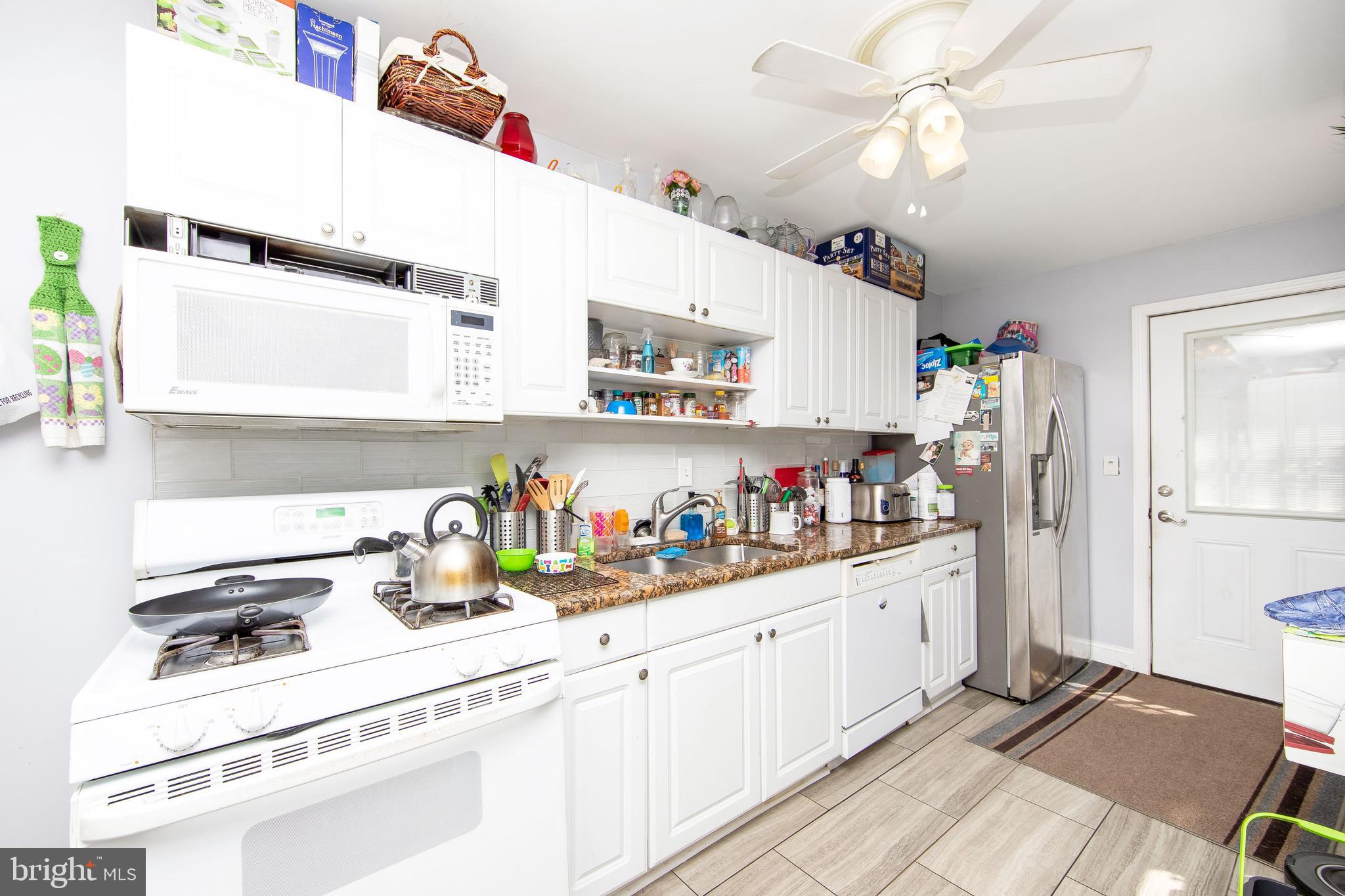 2832 Kansas Road Camden, NJ 08104 - Photo 9 of 32 a kitchen with refrigerator and cabinets