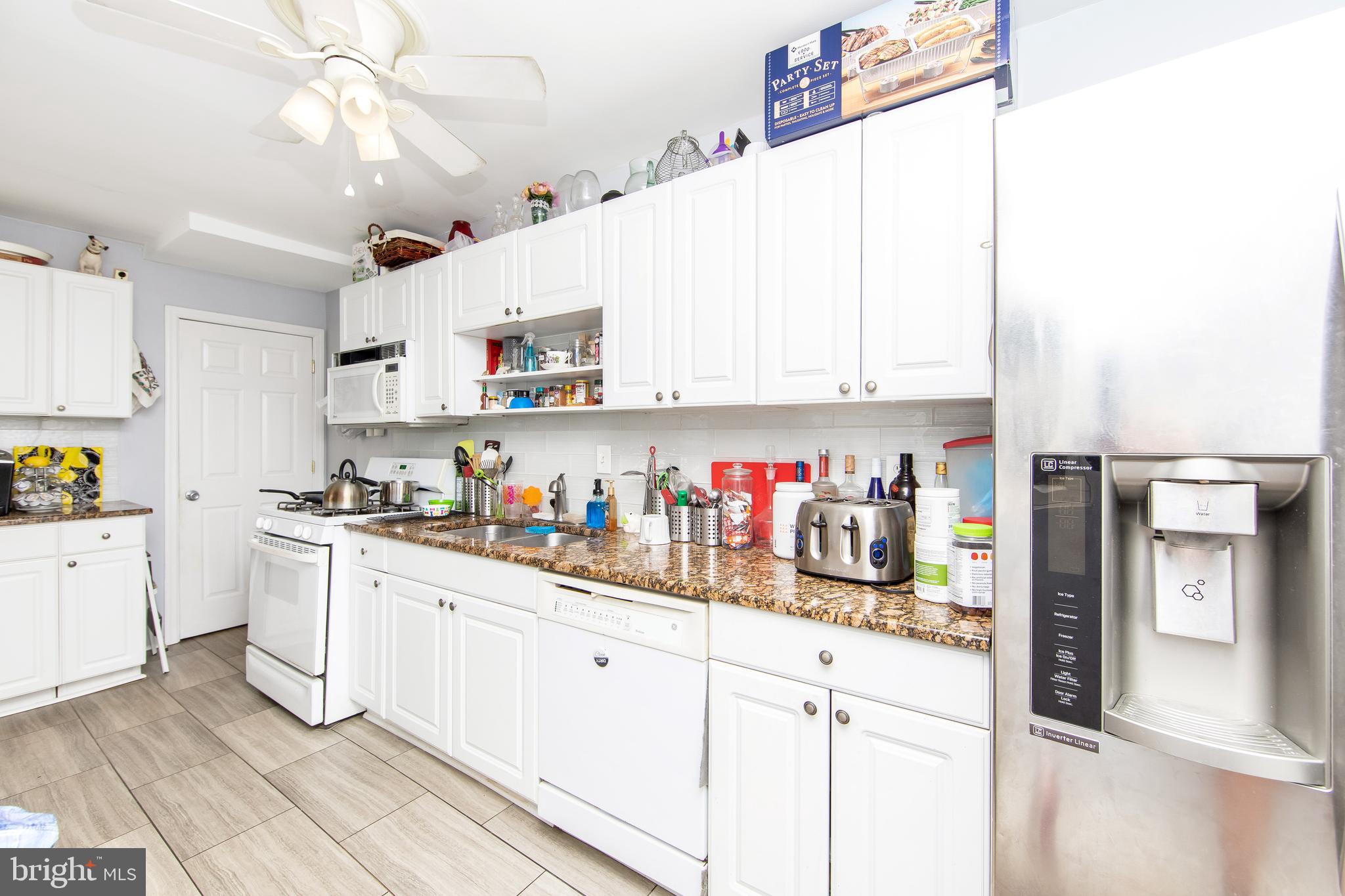 2832 Kansas Road Camden, NJ 08104 - Photo 10 of 32 a kitchen with refrigerator and cabinets