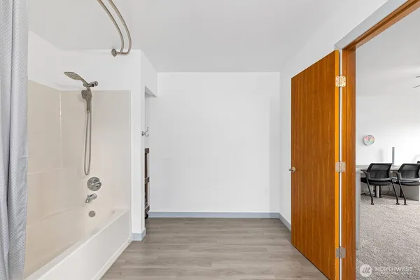 a view of a bathroom with a tub and shower