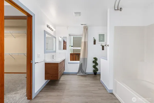 a view of hallway with wooden floor and stairs