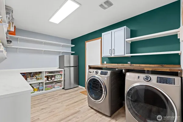 a utility room with sink dryer and washer